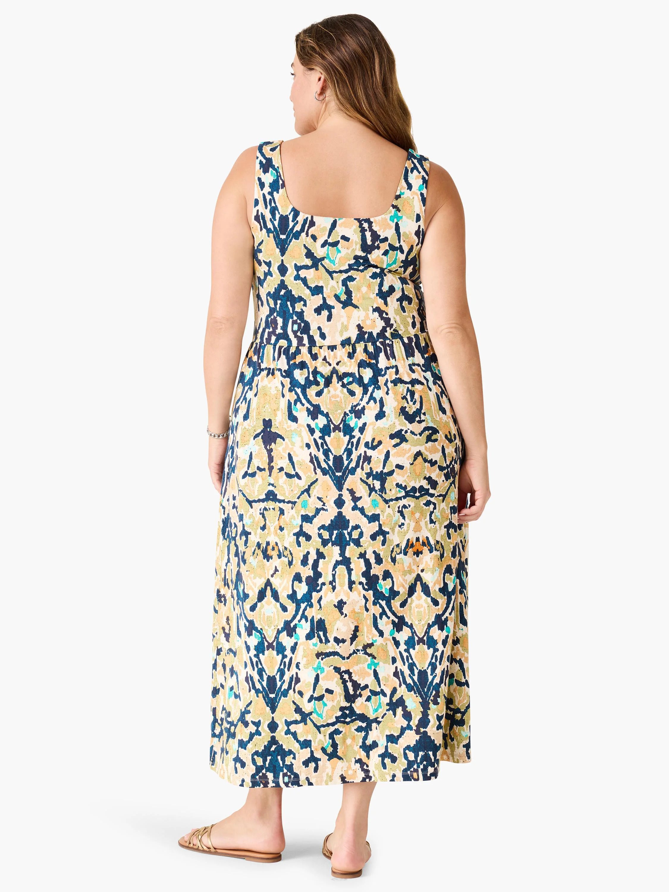 Sleeveless maxi dress, back view. Cream, deep teal, olive green abstract pattern, gathered waist.