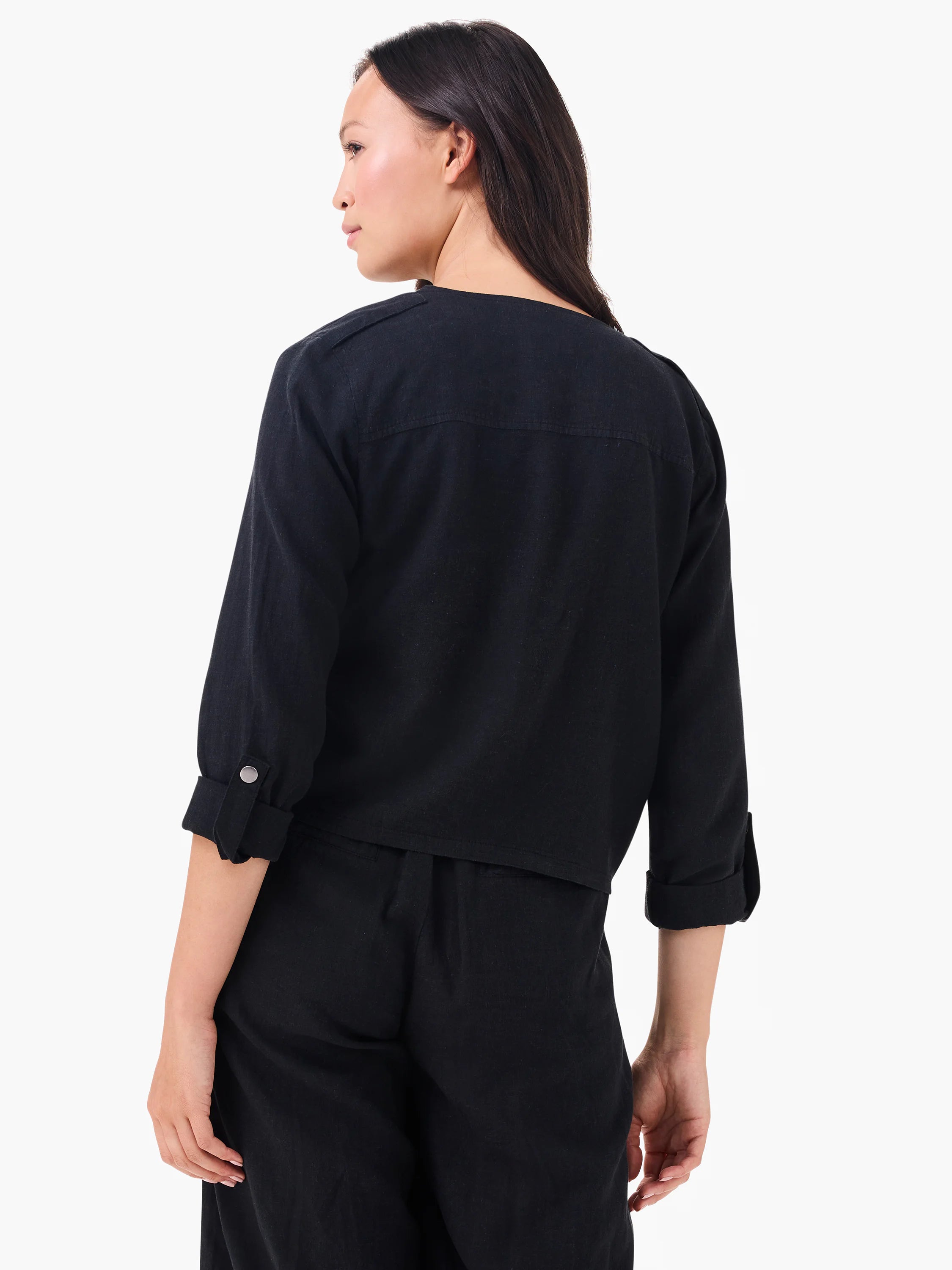 Cropped black linen moto jacket with shoulder epaulets and 3/4 sleeves rolled & secured with silver buttons.