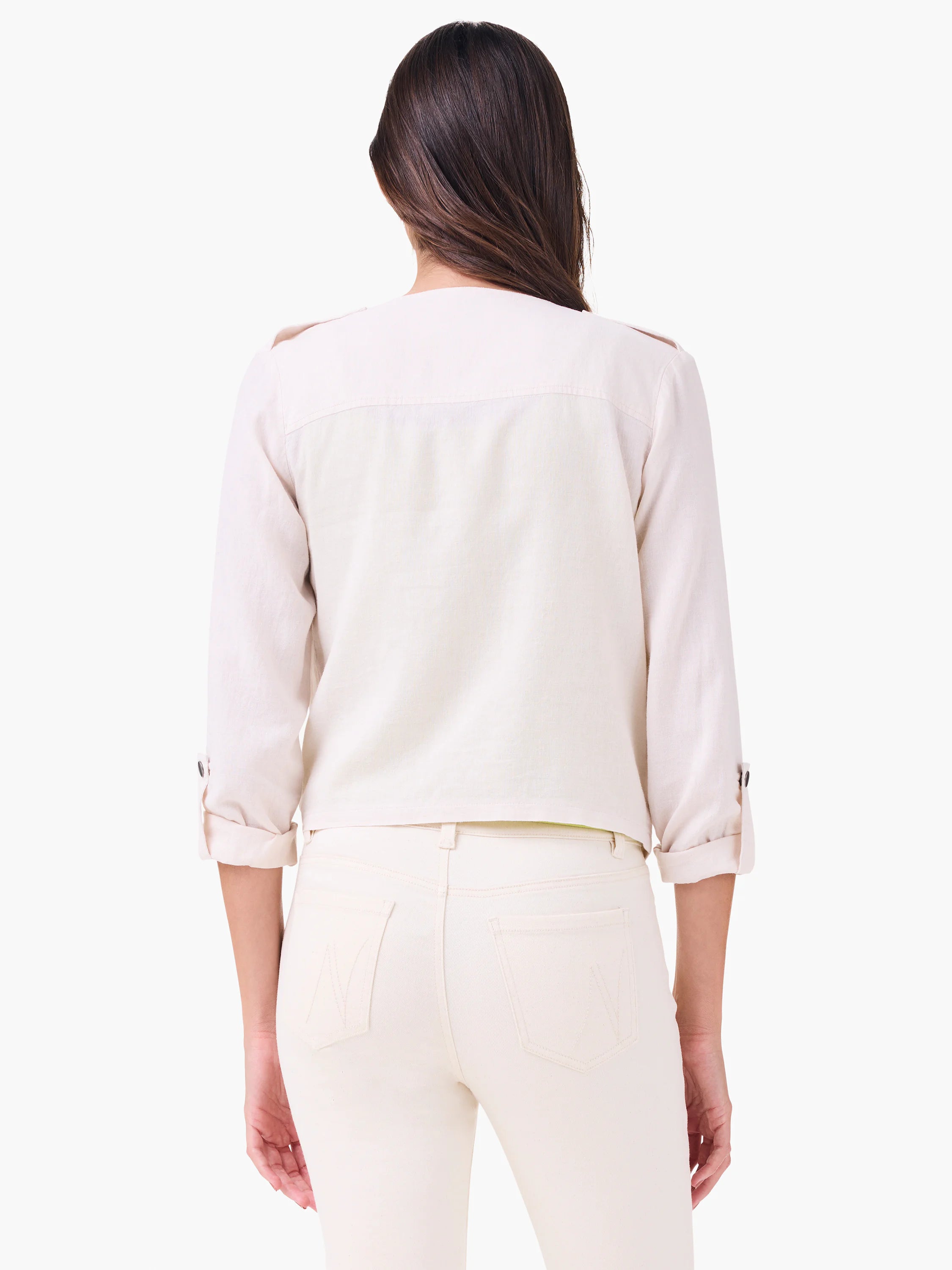Light cream linen moto jacket, back view. Rolled 3/4 sleeves with button tabs, shoulder epaulets.