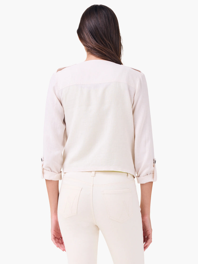 Light cream linen moto jacket, back view. Rolled 3/4 sleeves with button tabs, shoulder epaulets.