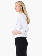 White linen moto jacket. Open front, cropped, 3/4 cuffed sleeves with tabs, 2 front flap pockets with snap buttons.