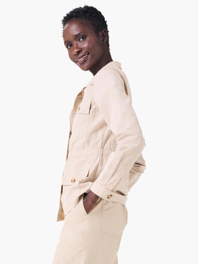 Khaki poplin jacket features two chest flap pockets, a gathered elastic waist, and coordinating buttons.
