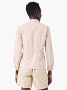 Beige poplin jacket with long sleeves and elasticized waist, shown from the back.