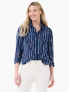 Navy shirt with white watercolor vertical stripes, collar, button-front, and rolled sleeves.