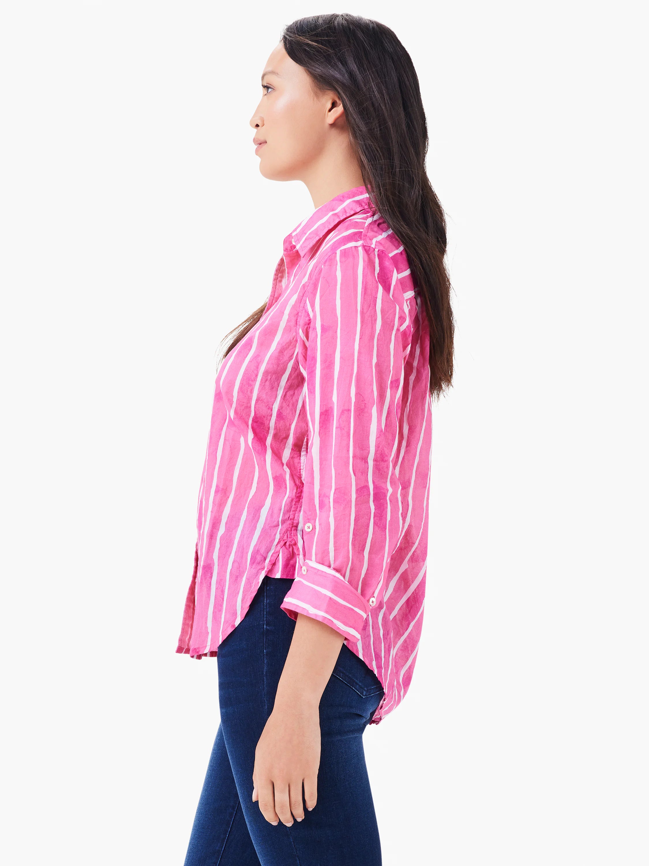 Pink button-up shirt with white watercolor-style vertical stripes. Long sleeves with rolled cuffs, relaxed fit.