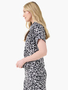 Black, white, and gray animal print short-sleeve collared top.