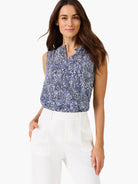 Navy blue and white sleeveless tank top with a scattered dot pattern and a split neckline.