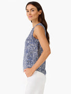 Sleeveless tank top featuring a scattered blue and white dot pattern. Relaxed fit.