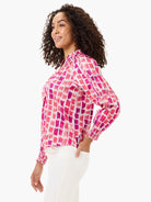 Top with pink & fuchsia brushstrokes on white, featuring smocked cuffs and a stand collar.