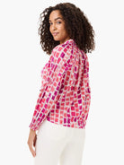 Loose blouse: pink and red brushstroke print, long smocked sleeves, gathered neckline.