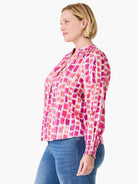 Pink and fuchsia brushstroke print top with V-neck, band collar, and long shirred sleeves.