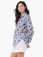 Loose-fitting boyfriend shirt with a vibrant, abstract pattern of multi-colored interlocking circles.
