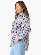 Boyfriend shirt with a multi-colored abstract pattern of interlocking circles in blues, greens, oranges, and pinks.