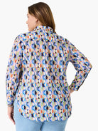 Relaxed fit shirt with an abstract pattern of segmented circles in bright blues, greens, oranges, pinks, purples, and black.