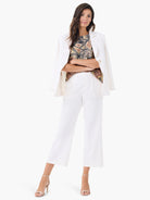 Sleeveless tank featuring a black, peach, and cream abstract dotty palm print.