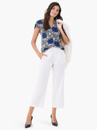 Petal Bloom Top: Blue & white abstract floral print with black outlines, short sleeves, V-neck.
