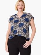 Blue, white, and black floral print V-neck top with short sleeves.
