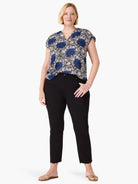 Blue, black, and white floral pattern top with a V-neck and short cap sleeves.