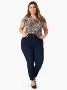 Off-white V-neck short-sleeve top with a dark brown and warm brown floral petal bloom print.