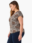 Brown, tan, white floral print V-neck top with cap sleeves.