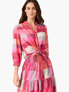 Shirt: Pink, fuchsia, orange & beige plaid pattern. Stand collar, 3/4 sleeves, knot tied at waist.
