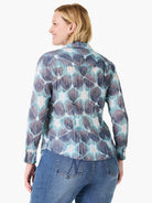 Crinkled button-down shirt with long sleeves, featuring an abstract pattern of blues, teal, brown, and light pink.