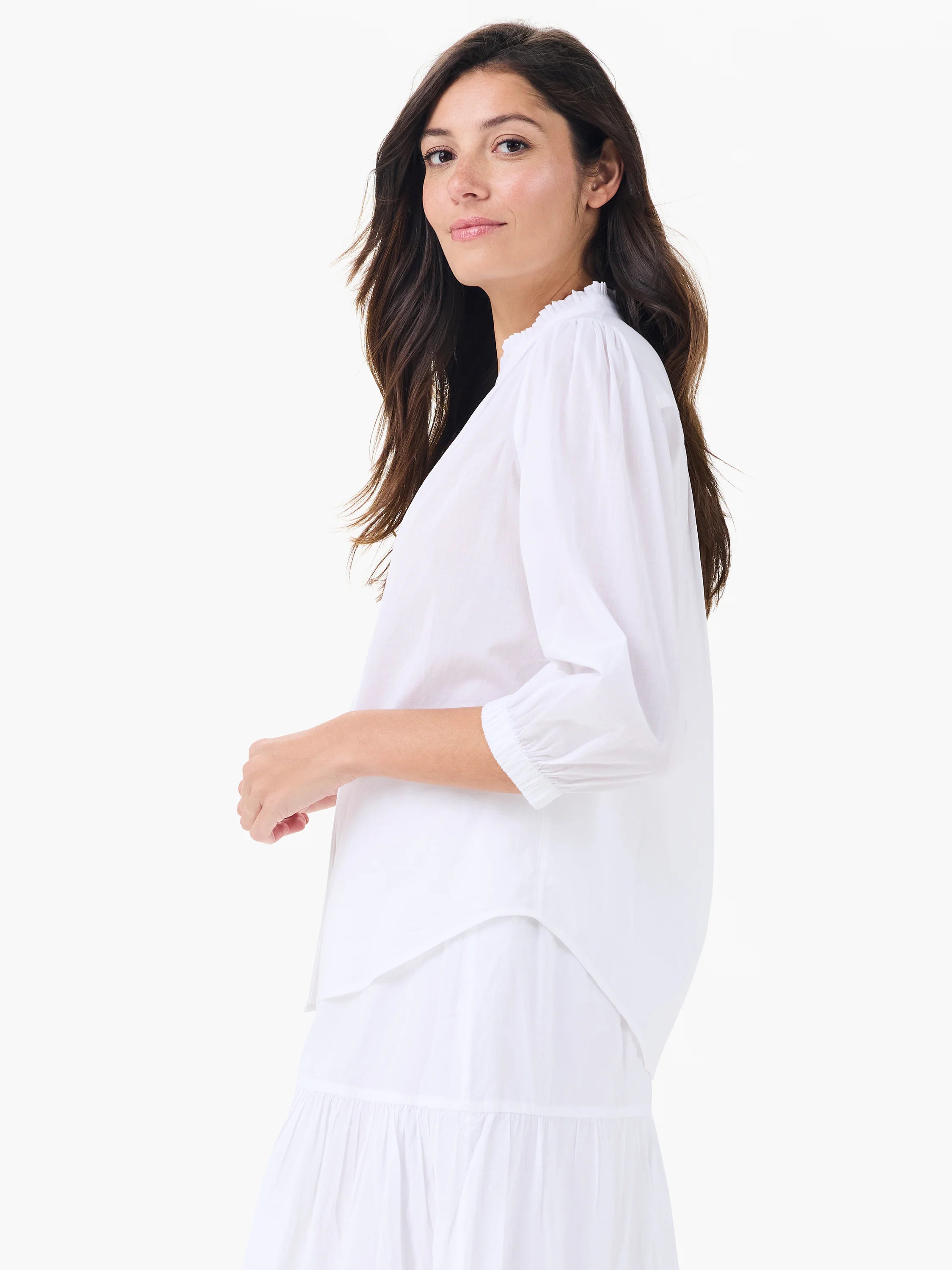 White cotton shirt with a ruffled collar, gathered 3/4 sleeves with elasticized cuffs, and a relaxed silhouette.