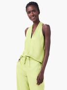 Lime green crepe halter top with a deep V-neck and a soft, draped silhouette.