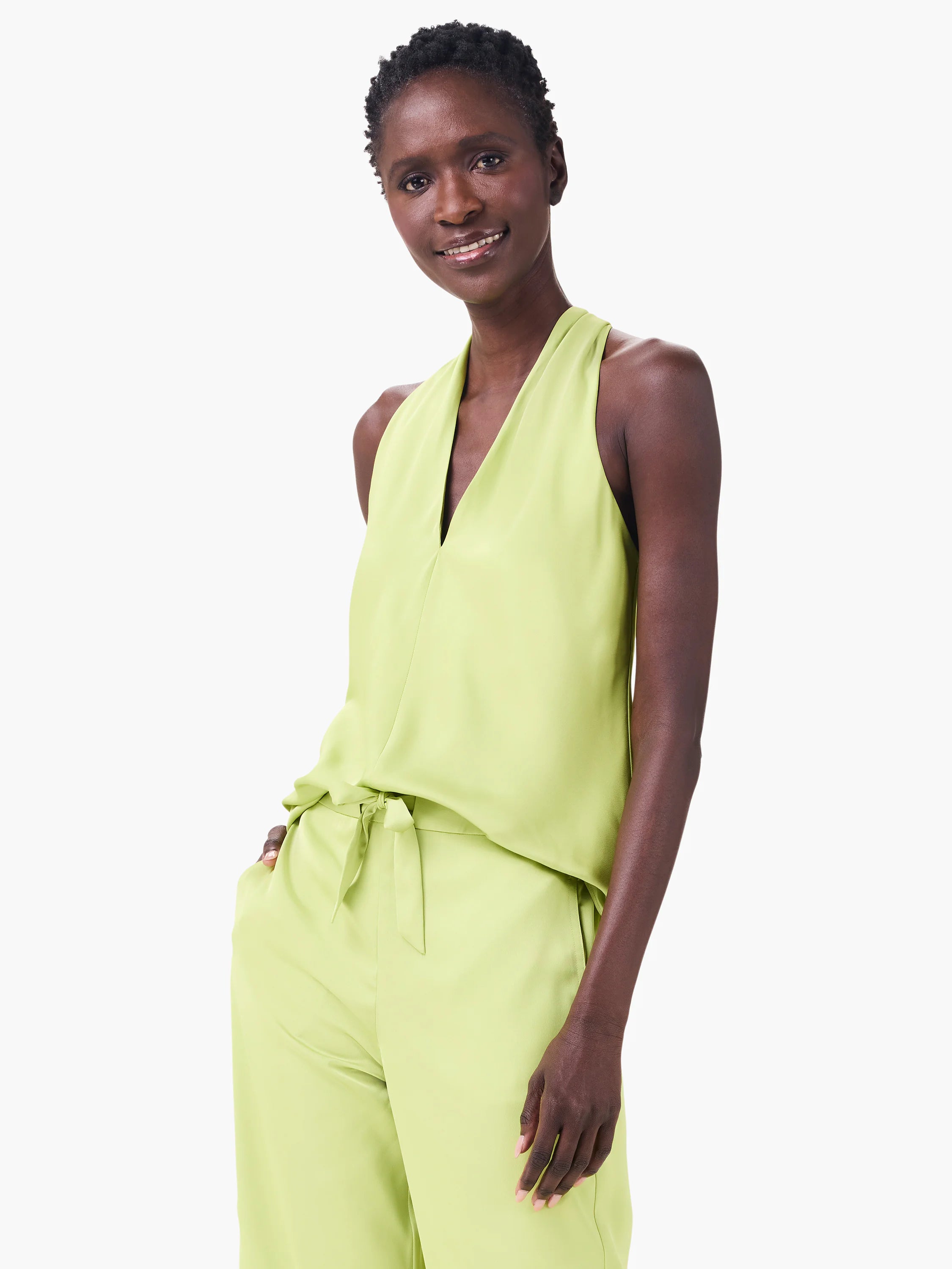 Lime green crepe halter top with a deep V-neck and a soft, draped silhouette.