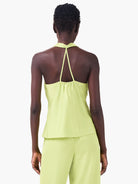 Lime green crepe halter top, back view. Features thin V-straps descending from neck, gathered elastic back.