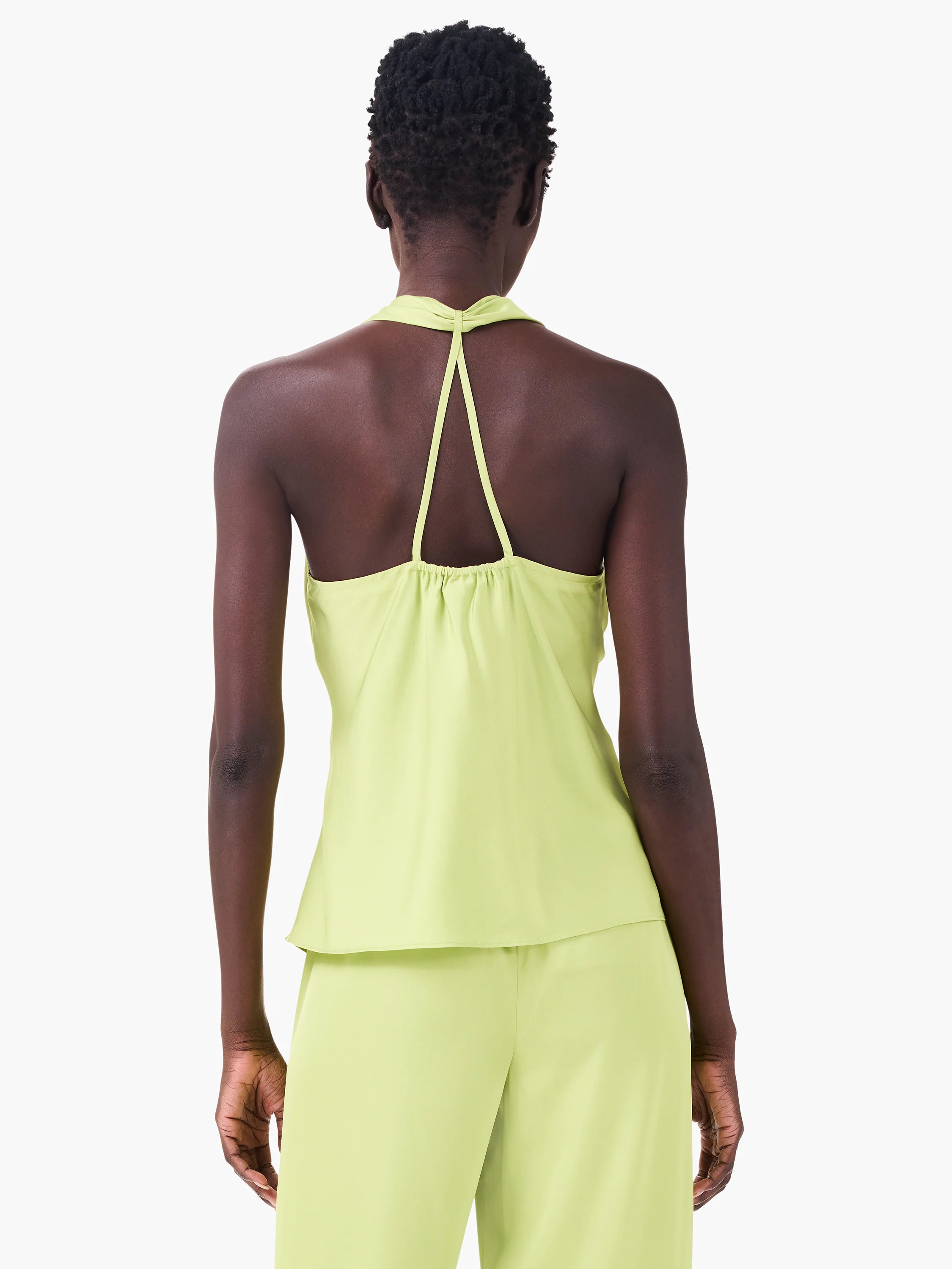 Lime green crepe halter top, back view. Features thin V-straps descending from neck, gathered elastic back.