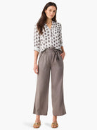 Light grey button-front shirt with dark grey clover-stamp pattern. Band collar, rolled long sleeves.