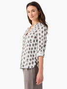 White shirt with gray & taupe clover stamp pattern. Features V-neck, button front, rolled sleeves, and chest pockets.