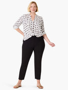 White shirt with gray clover stamp pattern, V-neck, roll-tab sleeves, and chest pockets.