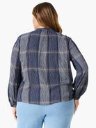 Here's alt text under 125 characters:

"Navy blue and white vertically striped blouse with long sleeves and a ruffled...