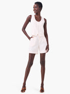 Off-white linen vest and shorts; button front closure.