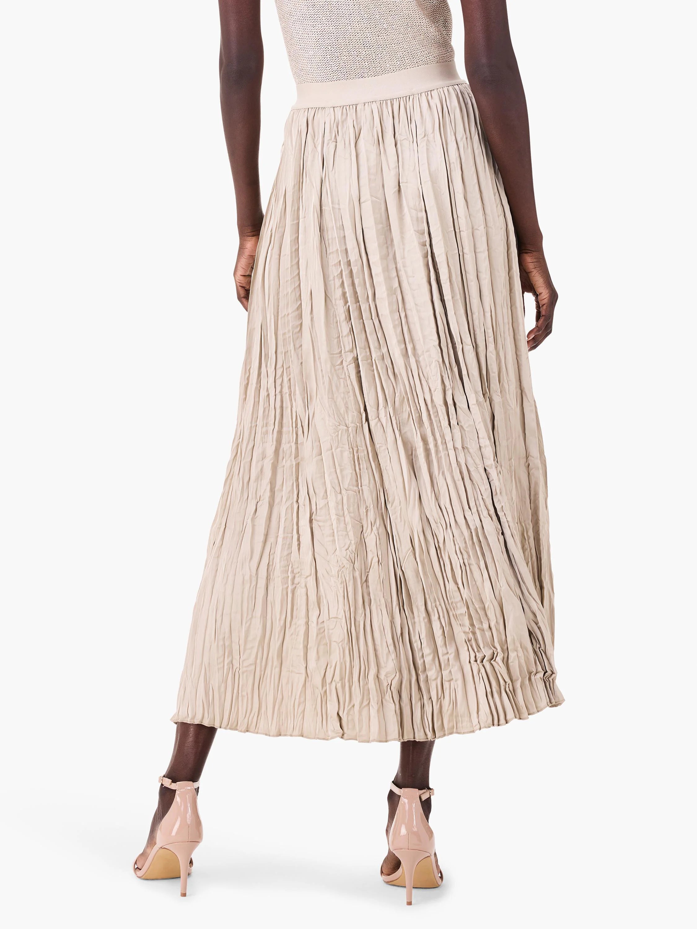 Light beige crinkled maxi skirt with irregular vertical folds and a textured, gathered appearance.