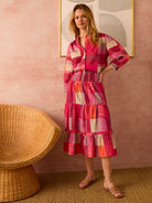 Midi-length tiered skirt in sunset-toned plaid.  Features pink, orange, and beige blocks.