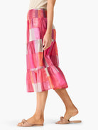 Mid-length tiered skirt in pink, orange, and gray plaid pattern.  Elastic waistband.