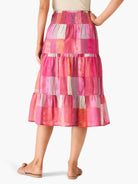 Tiered midi skirt in sunset hues; pink, orange, and beige plaid pattern.  Elastic waistband.