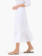 White cotton tiered midi skirt.  Features multiple ruffles at the hem.