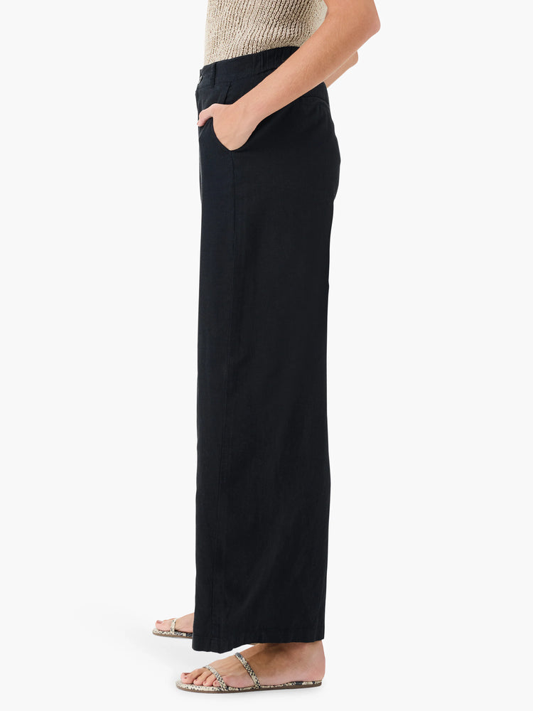 Black wide-leg linen trousers; side view.