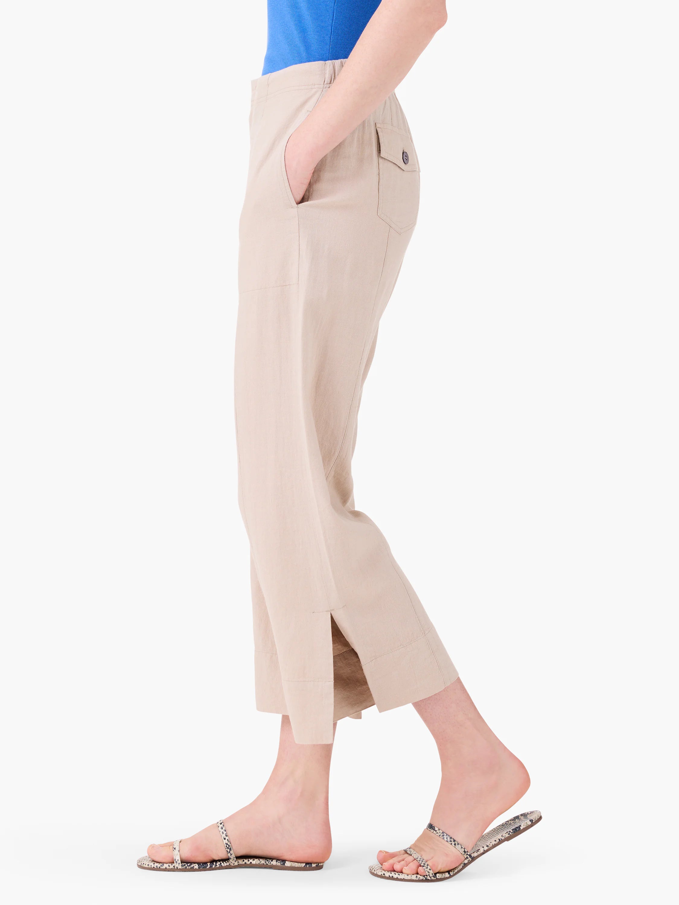 Tan wide-leg cropped pants with side slash pockets, a buttoned back flap pocket, and small side slits at the hem.