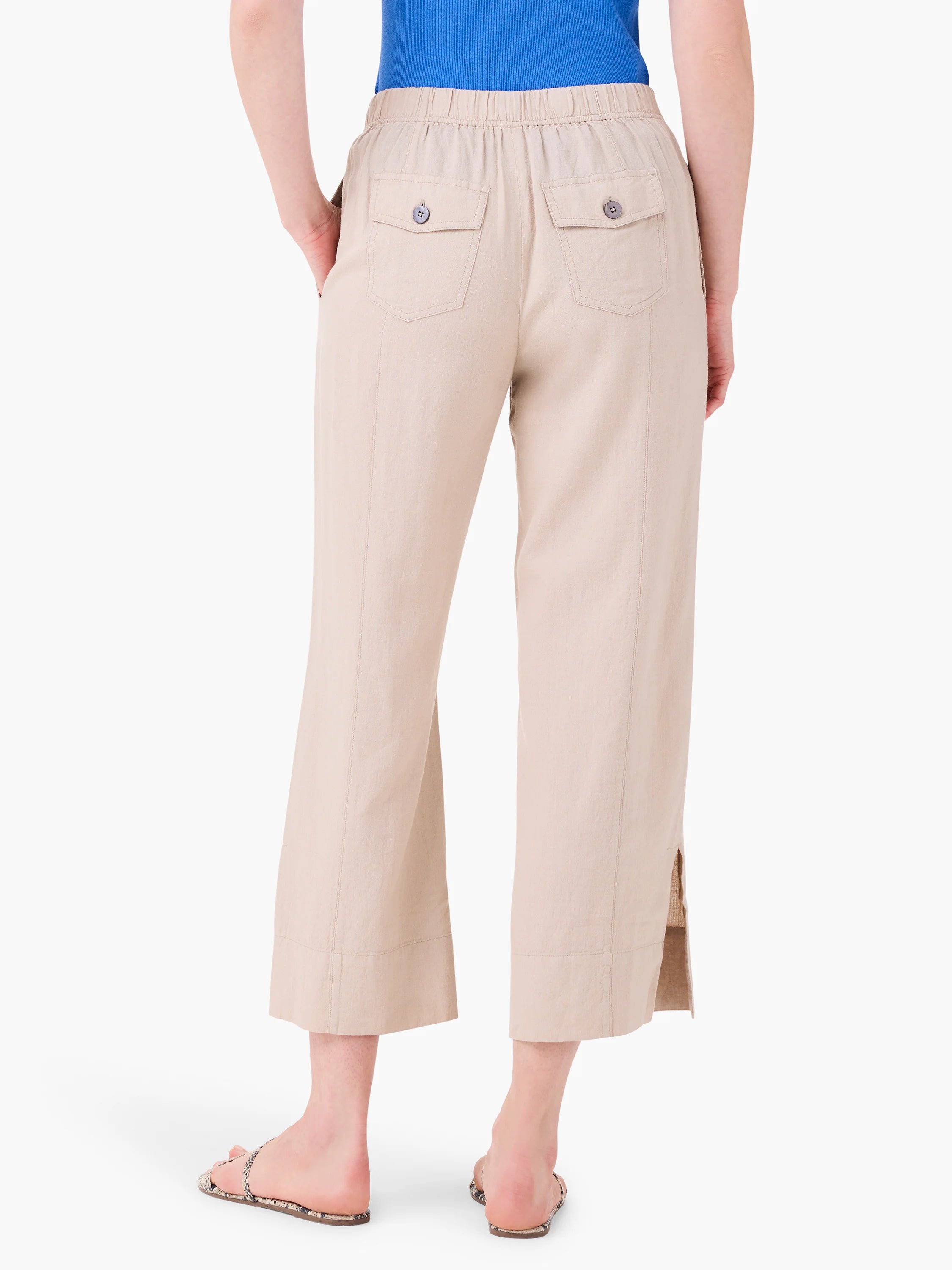 Light beige wide-leg crop pants with elastic waist, two back button pockets, and small side slits at the hem.