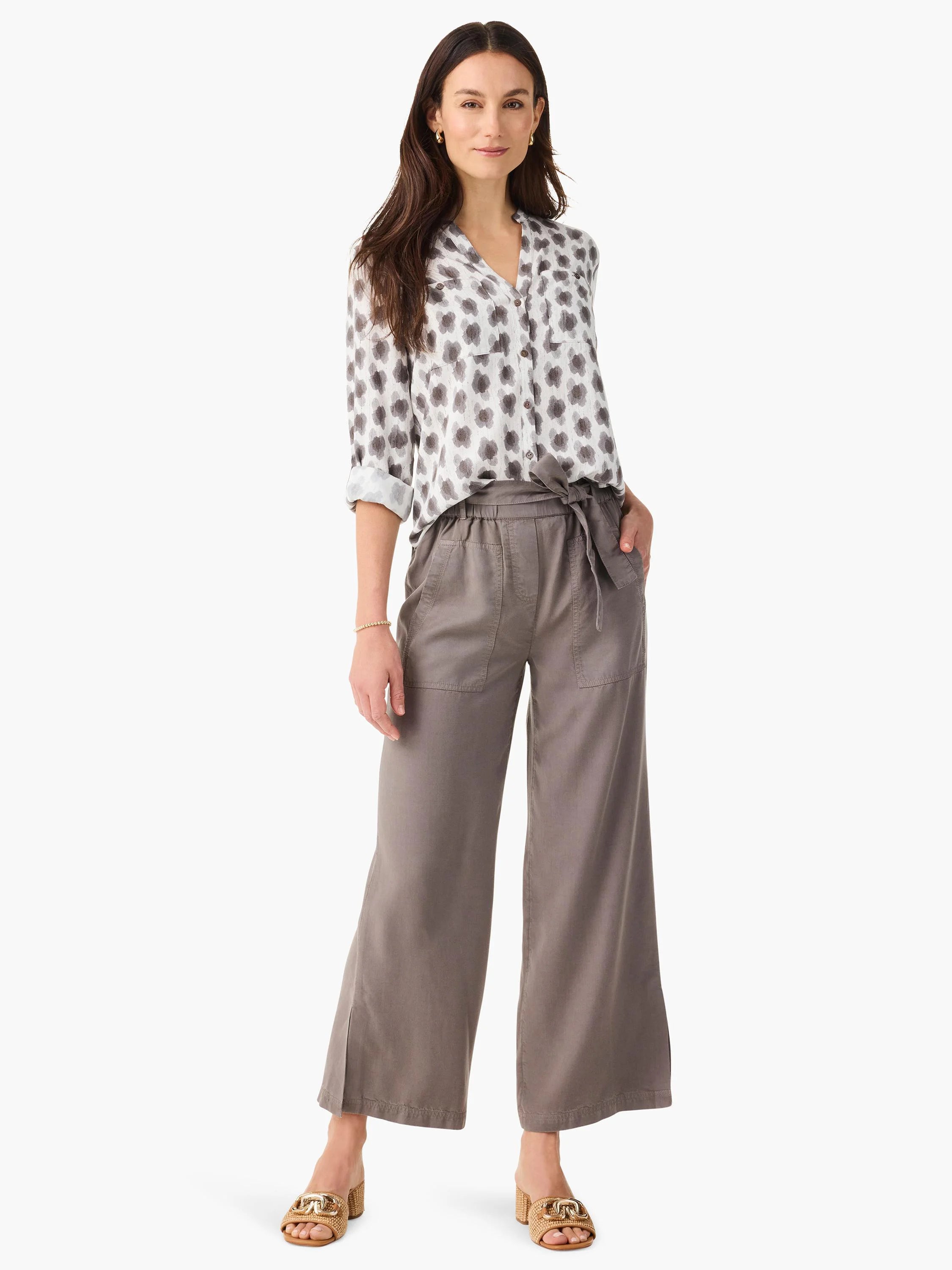 Drapey olive gray wide-leg utility pants feature a self-tie waist, prominent front pockets, and ankle slits.