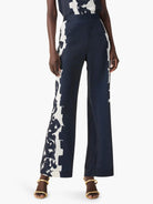 Wide-leg pants; navy blue with off-white abstract floral print down one side.