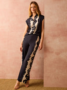 Wide-leg pants; predominantly dark navy with off-white abstract rose print down the sides.