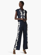 Wide-leg pants; navy blue with off-white abstract floral print down the sides.
