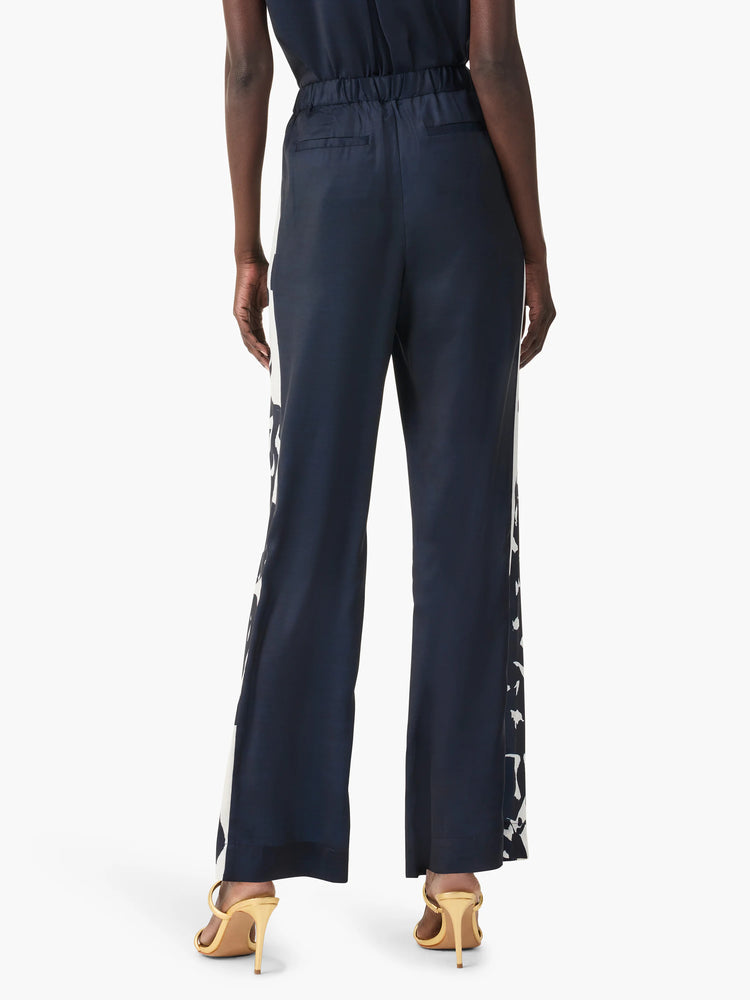 Navy blue wide-leg pants with off-white abstract side panels.  Elastic waistband.