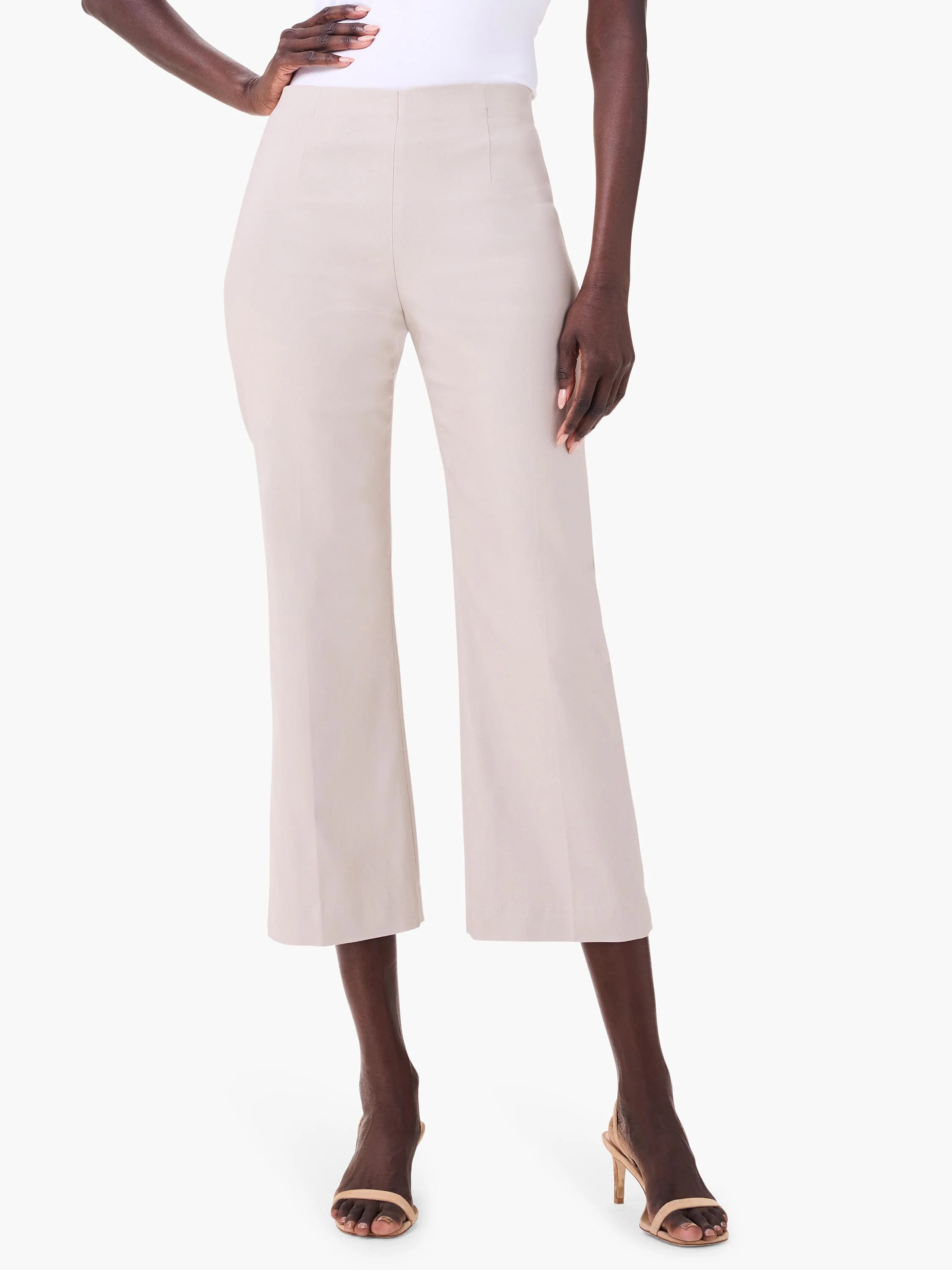 Light beige high-waisted wide-leg crop pants with front creases, worn by a model.